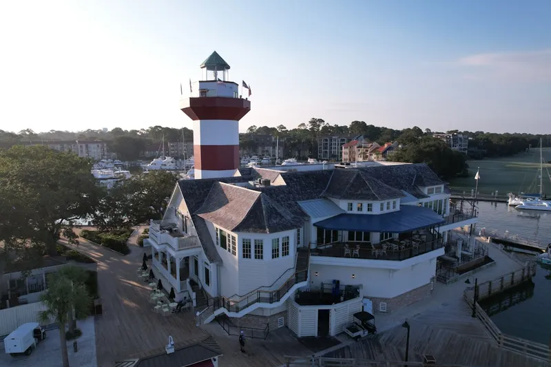A lighthouse tops a harbor-side building.